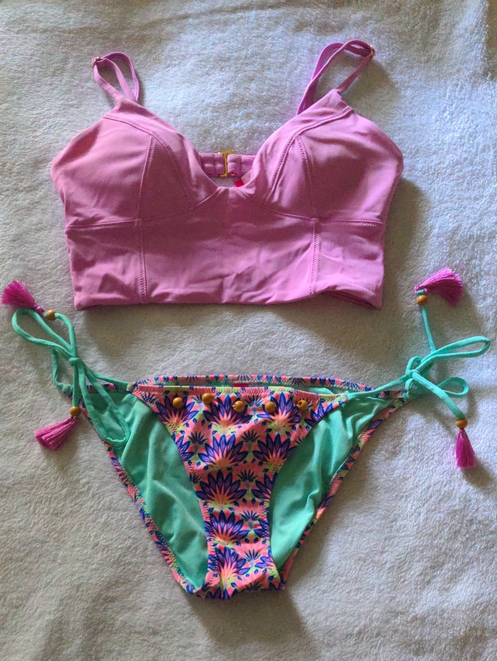 Victoria's Secret Pink Bikini Top with Gold Hardware with Colorful Bottoms.